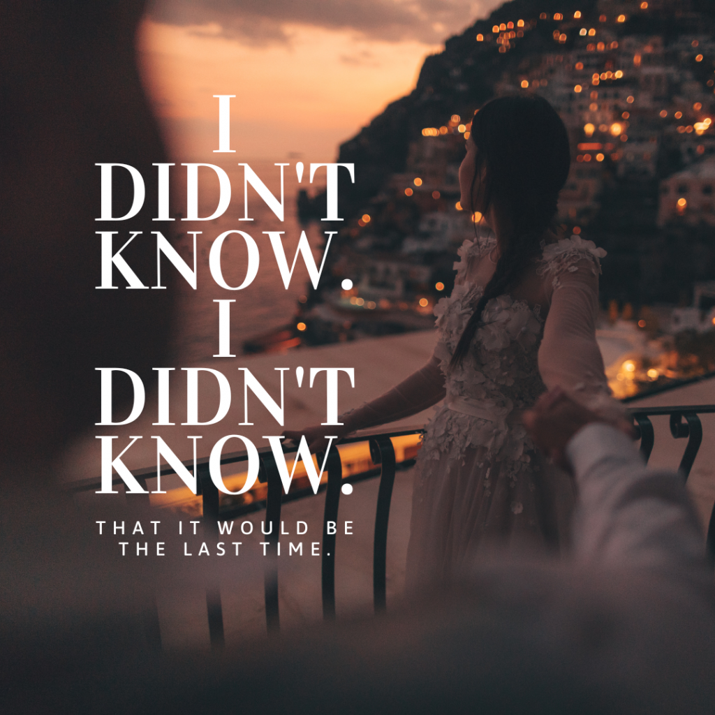 A woman holding someone's hand on a balcony, looking back over her shoulder at the lights of an old city on an adjacent cliffside. Words in white read "I didn't know. I didn't know. That it would be the last time."