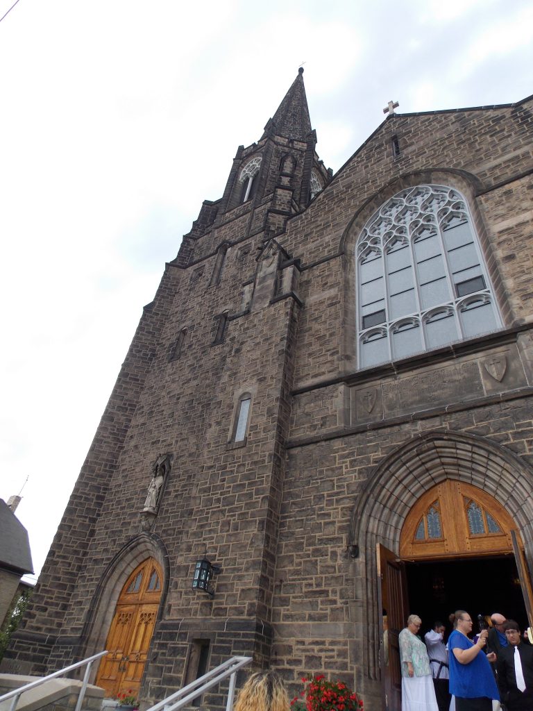 Dark brown stone cathedral-style church.