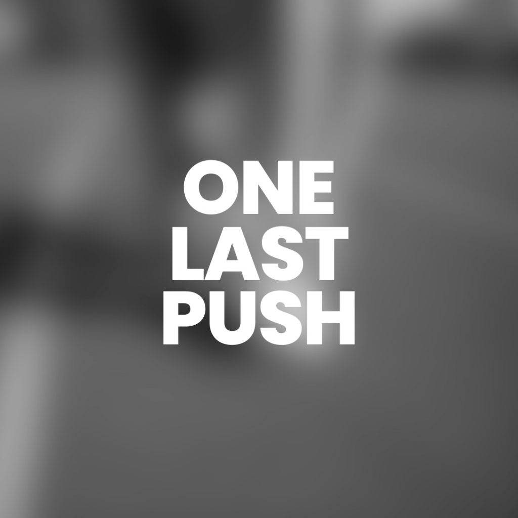 Gray blurred background. Words in white: "one last push"