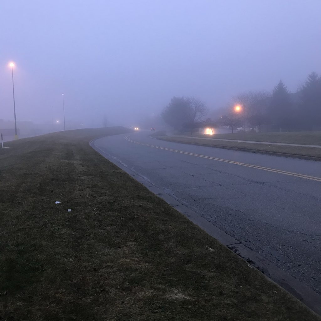 A misty street around daybreak.