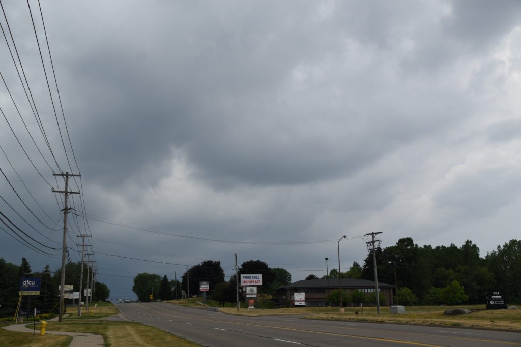 Road with building storm clouds.